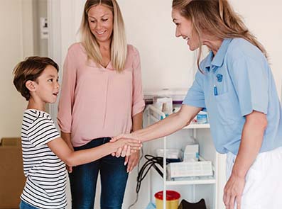 Doktor, patient, barn med mamma.