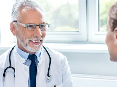 doctor in his office smiling at patient